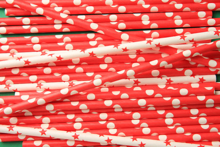 Many paper drinking straws on green background, above viewの写真素材