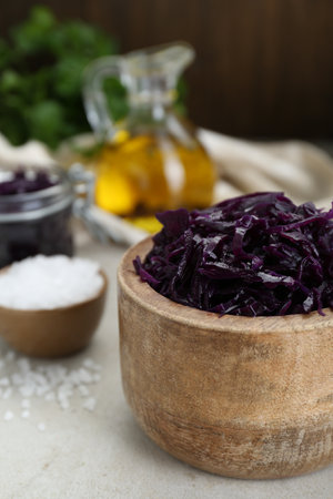 Tasty red cabbage sauerkraut and different ingredients on tableの写真素材