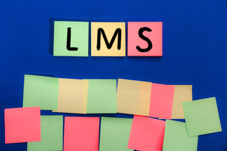 learning management system. Colorful sticky notes with abbreviation LMS on blue background, top viewの写真素材