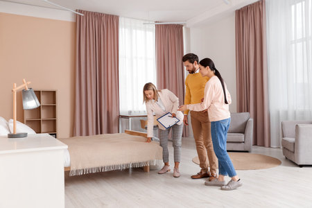 Real estate agent showing new apartment to coupleの写真素材
