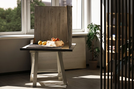 Juicy fruits and double-sided backdrops on table in photo studioの写真素材