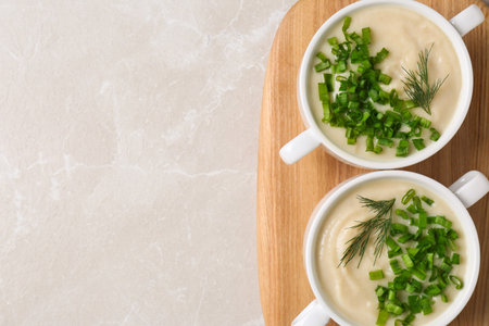 Bowls with tasty creamy soup of parsnip on light gray background, top view. Space for textの写真素材