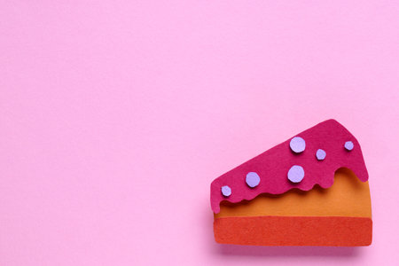birthday party. Piece of paper cake on pink background, top view. Space for textの写真素材