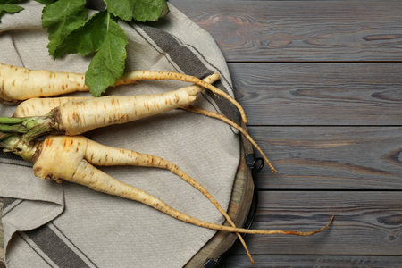 Tasty fresh ripe parsnips on gray wooden table, top view. Space for textの写真素材