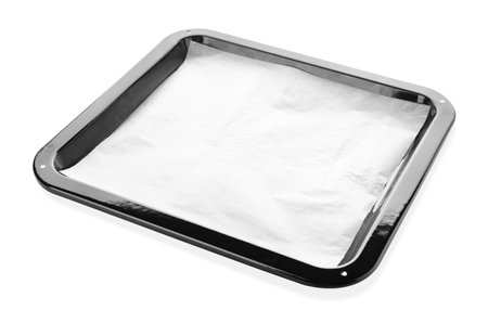 Baking pan with parchment paper isolated on whiteの写真素材