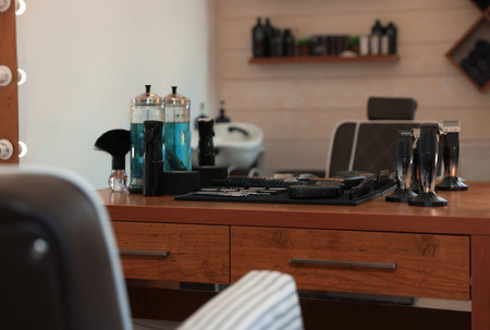Stylish hairdresser's workplace with professional tools and cosmetic products in barbershopの写真素材