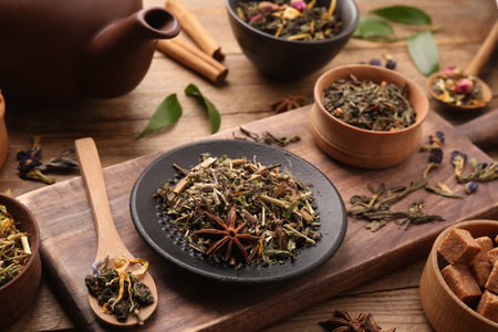 Different dry aromatic teas on wooden tableの写真素材