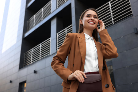 Young woman in formal clothes near building outdoors, space for textの写真素材