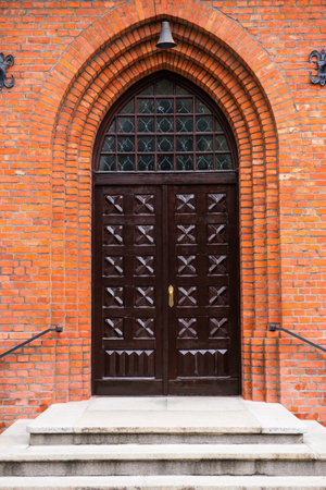 Entrance of building with beautiful arched wooden doorの写真素材