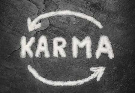 Drawn circle and word Karma made of sea salt on dark background, flat layの写真素材