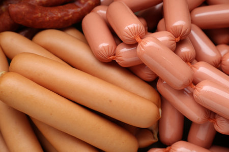 Different tasty sausages as background, closeup viewの写真素材
