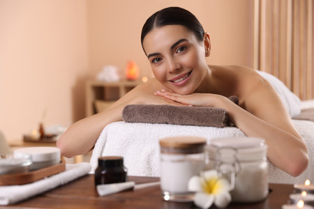 Young woman resting on massage couch in spa salonの写真素材