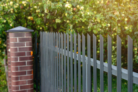 Beautiful brick fence with iron railing outdoorsの写真素材