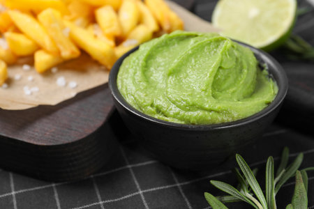 French fries, lime, rosemary and avocado dip on serving board, closeupの写真素材