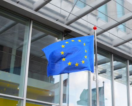 Flags of Netherlands and European Union near building on sunny dayの写真素材