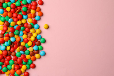 Tasty colorful candies on pink background, flat lay. Space for textの写真素材