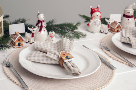 Luxury place setting with festive beautiful decor for Christmas dinner on white tableの写真素材