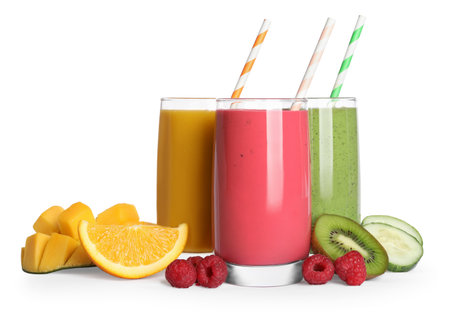 Glasses with delicious smoothies and ingredients on white backgroundの写真素材