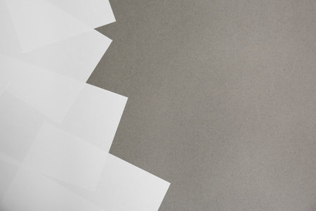 Blank white paper sheets on gray background, flat lay. Space for text