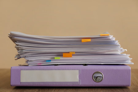 Stack of documents and office folder on wooden table against brown backgroundの写真素材