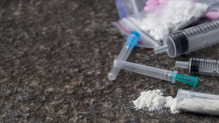 Pills, syringes and powder on stone surface, closeup with space for text. hard drugs