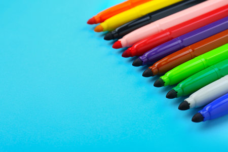 Many different colorful markers on light blue background, closeup. Space for textの写真素材