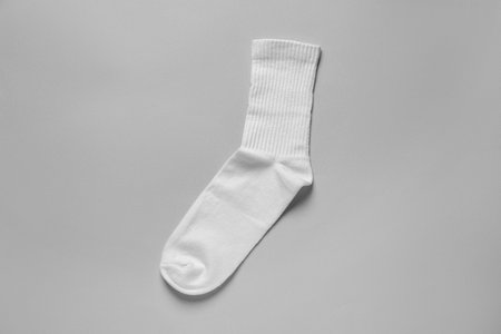 One white sock on light gray background, top viewの写真素材