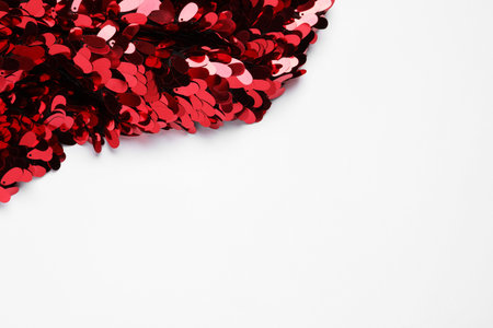Beautiful red sequin fabric on white background. Space for textの写真素材