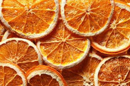Many dry orange slices as background, top view