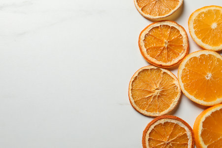 Dry orange slices on white table, flat lay. Space for textの写真素材