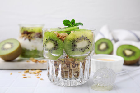 Delicious dessert with kiwi and muesli on white table, closeupの写真素材