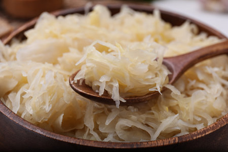 Spoon and bowl of tasty sauerkraut, closeup viewの写真素材