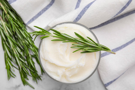 Delicious pork lard with rosemary in glass on white marble table, flat layの写真素材