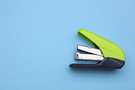 New bright stapler on light blue background, top view. Space for textの写真素材