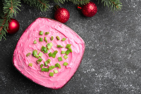 Herring under fur coat salad and Christmas decor on gray table, flat lay with space for text. Traditional Russian dishの写真素材