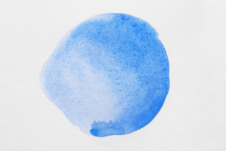 Blot of blue watercolor paint on white background, top viewの写真素材