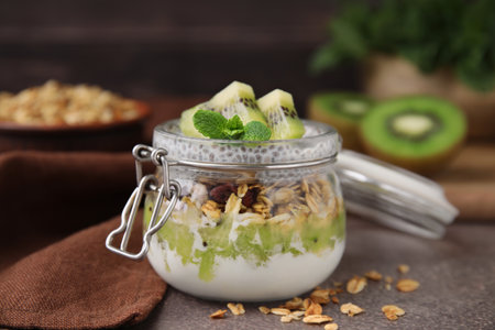 Delicious dessert with kiwi and chia seeds on brown table, closeupの写真素材