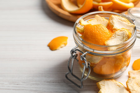 Orange peels preparing for drying on white wooden table, closeup. Space for textの写真素材