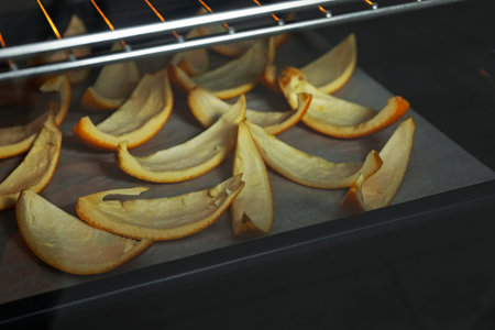 Baking tray with orange peels in oven, closeupの写真素材