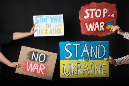 Stop war in Ukraine. People holding posters on black backgroundの写真素材