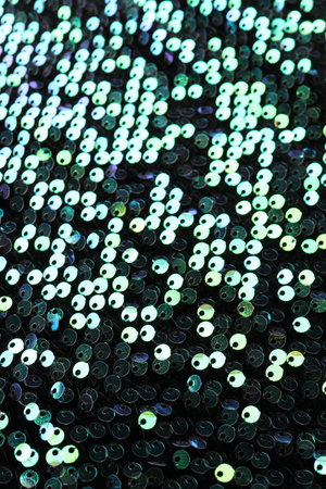 Beautiful dark sequin fabric as background, closeupの写真素材