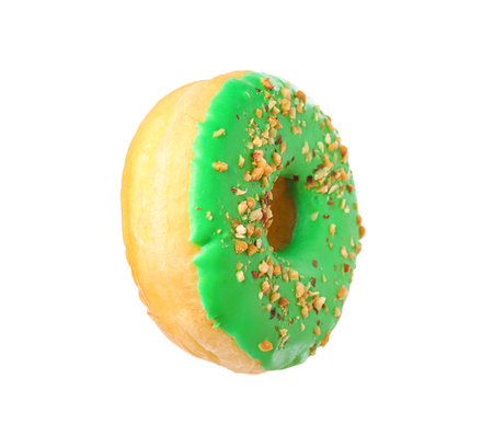 Sweet tasty glazed donut decorated with nuts isolated on whiteの写真素材
