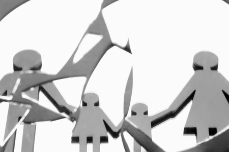 Human figures reflected in broken mirror on gray background, closeup. Divorce conceptの写真素材