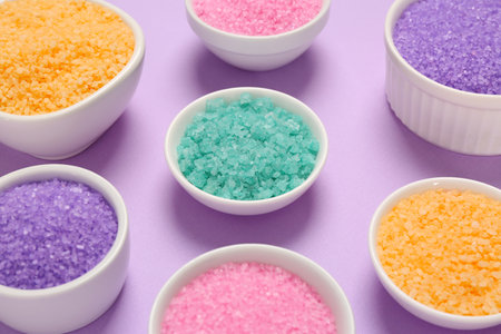 Different types of aromatic sea salt on purple backgroundの写真素材