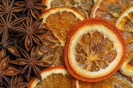 Dry orange slices and anise stars as background, top viewの写真素材