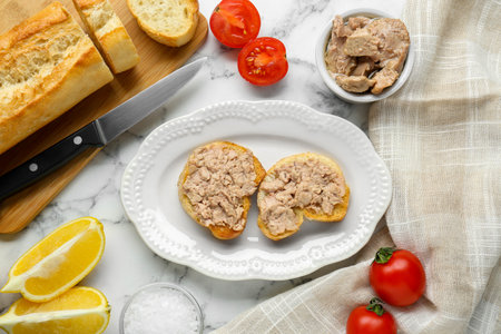 Tasty sandwiches with cod liver on white marble table, flat layの写真素材
