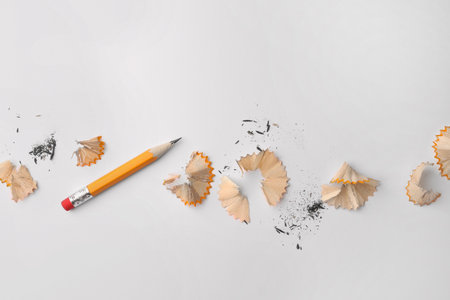 Graphite pencil and shavings on white background, flat layの写真素材