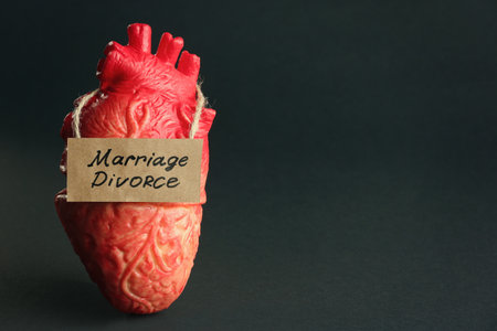 Model of heart and card with words Marriage Divorce on black background. Space for textの写真素材