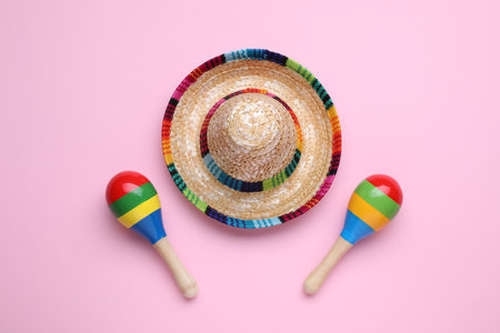 Colorful maracas and sombrero hat on pink background, flat lay. musical instrumentsの写真素材