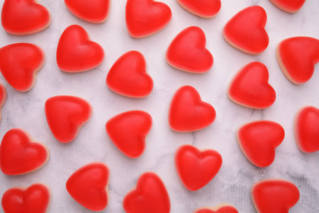 Delicious heart shaped jelly candies on white marble table, flat layの写真素材